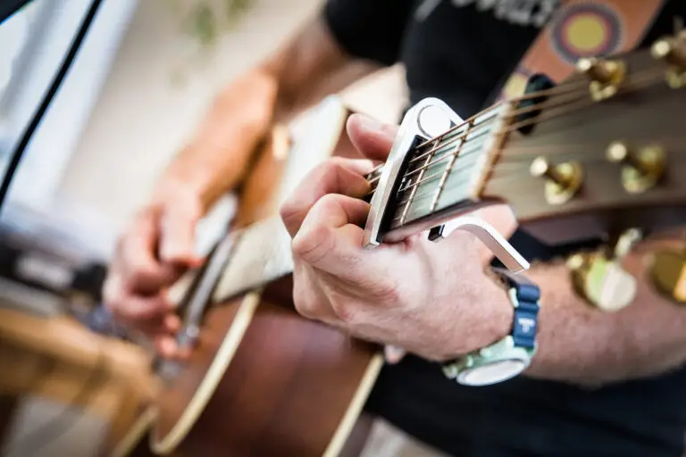Person playing guitar from up close