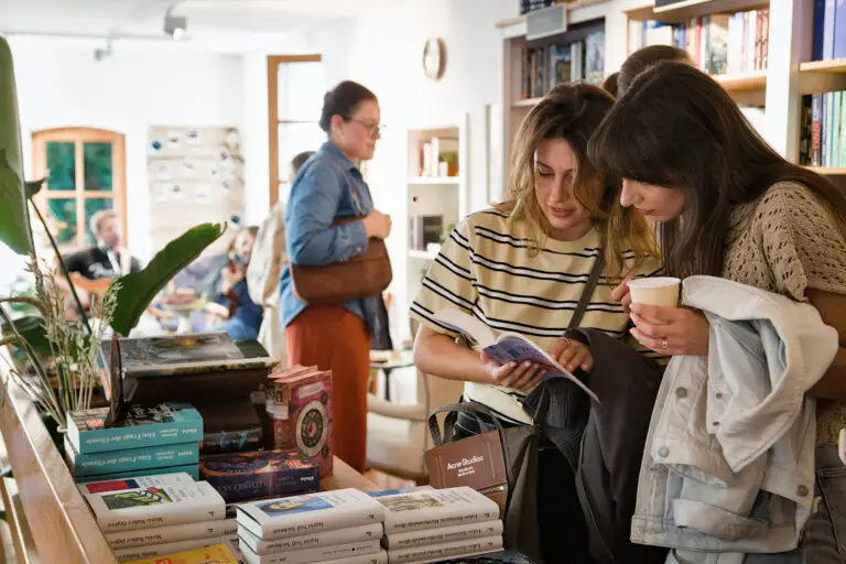 Friends looking at books during the Grand opening event