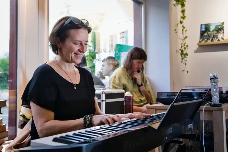 Keyboard player playing and smiling