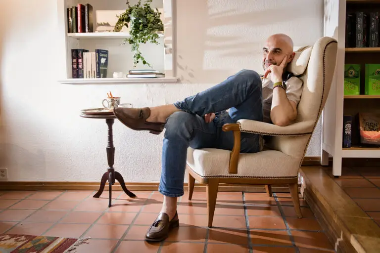 Many relaxing in a chair, looking intelligent