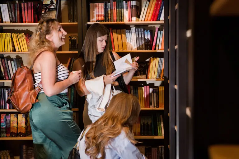 Women in front of bookshelf at Cozy Place Books & Coffee Basel